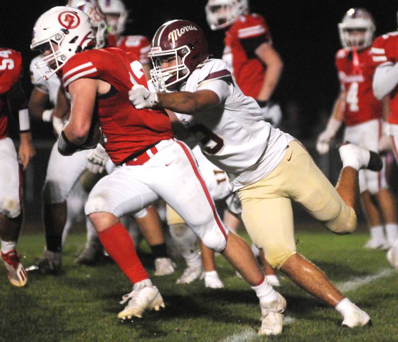 Morris' Logan Sparrow (19) tackles Ottawa's Ethan Poutre on Friday, Oct. 10, 2025 at King Field in Ottawa.