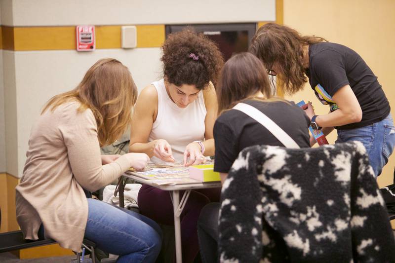 Teams compete in a 500 piece puzzle speed race competition on Saturday, Jan. 27,2024 at the Elmhurst Library in Elmhurst.