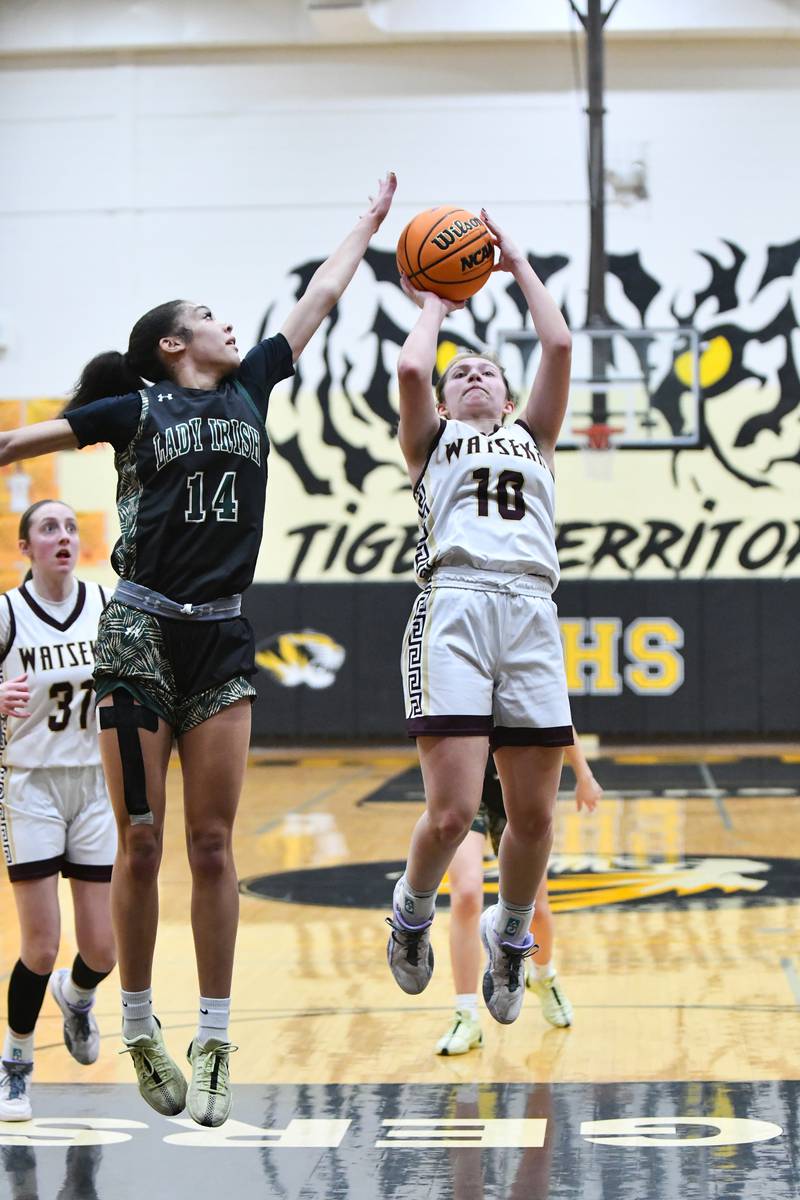 Bishop McNamara's Jaide Burse defends a shot by Watseka-Milford's Christa Holohan during the Fightin' Irish's 69-38 victory over Watseka-Milford in the IHSA Class 2A Herscher Sectional championship on Thursday, Feb. 27.