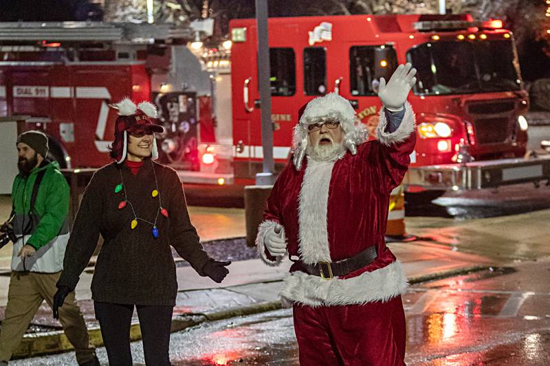 Nikki Lovett escorts Santa from his Dixon City Fire Department sleigh at the KSB tree lighting ceremony during the Dixon Christmas walk Friday, Dec. 1, 2023.