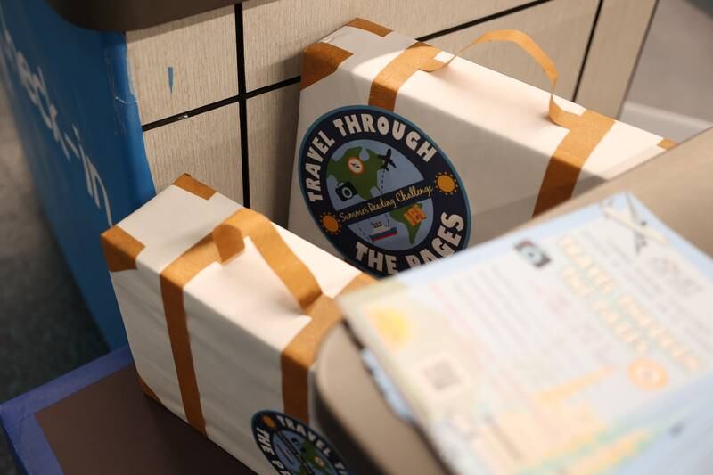 Hand crafted travel luggage sits at the information dest at the Joliet Public Library Ottawa Street Branch for their Travel Through the Pages summer reading program on Thursday May 30, 2024 in Joliet.