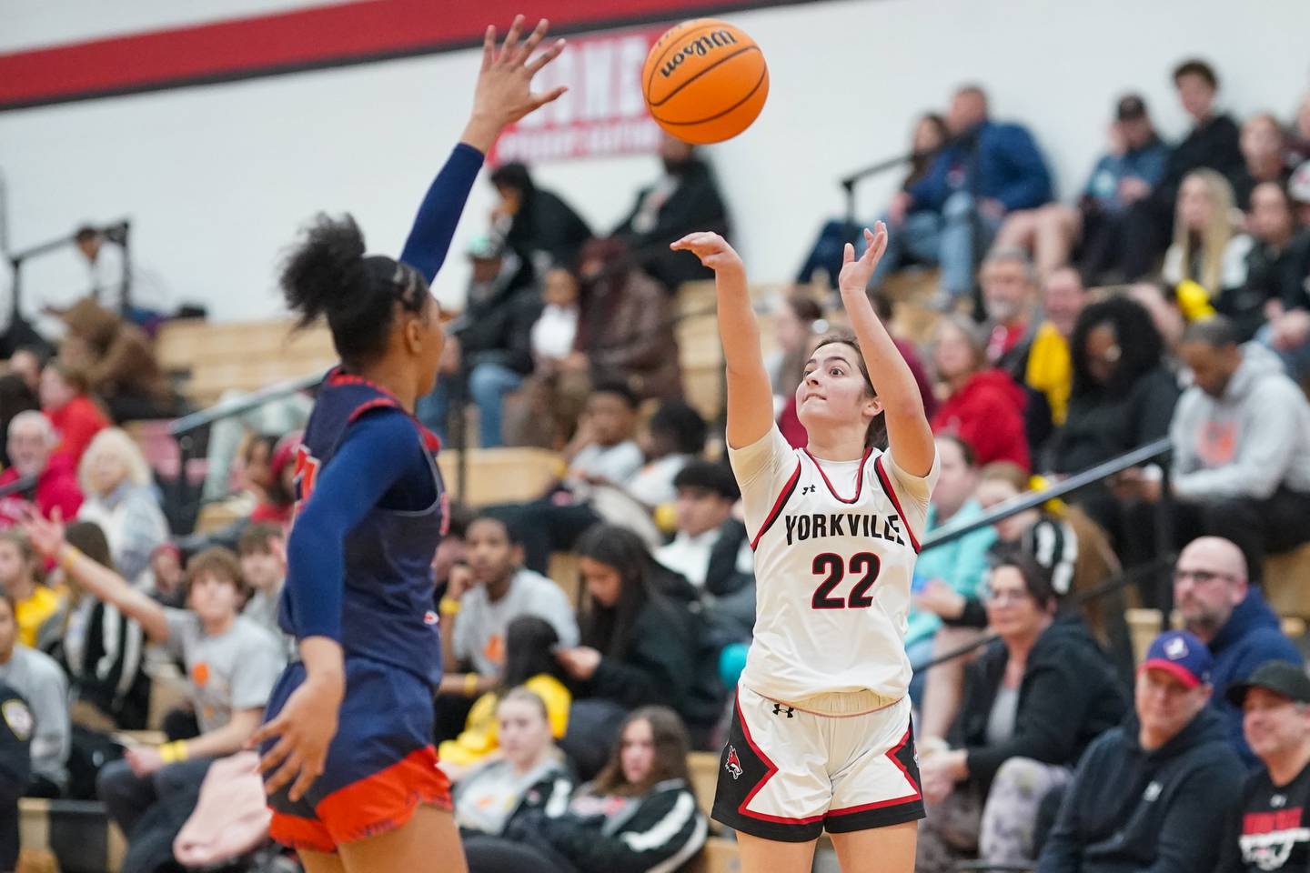 Yorkville's Sydney McCabe (22) shoots a three pointer against Oswego's Payttton Wiggins (24) during a hoops for hope basketball game at Yorkville High School on Saturday, Feb. 8, 2025.