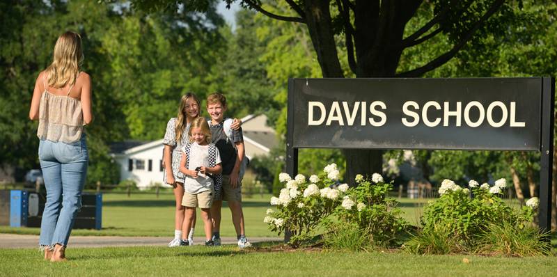 Lindsey Wagner photographs her children, Elle, Grey and Brody on the first day of classes at Davis Elementary in St. Charles on Wednesday, Aug 13, 2025.