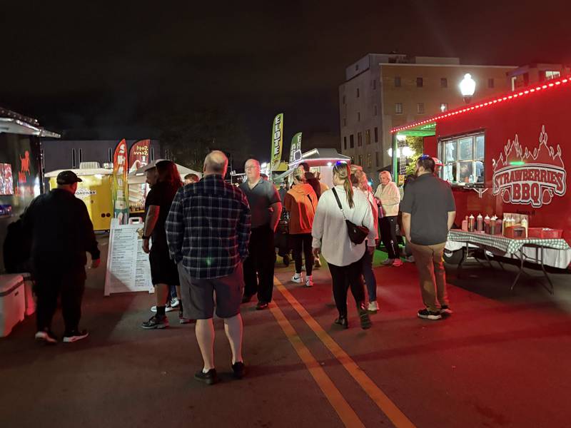 People explore food trucks at the Lumenaura light and sound experience in Aurora Oct. 10, 2025.