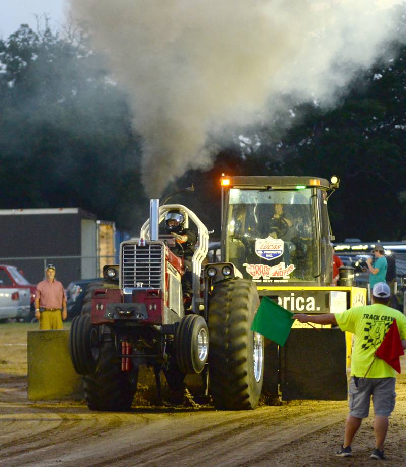 Jake Cook of Ladd starts his modified tractor at the Illini Truck & Tractor Pulls at the Ogle County Fair on Thursday, Aug. 1, 2024.
