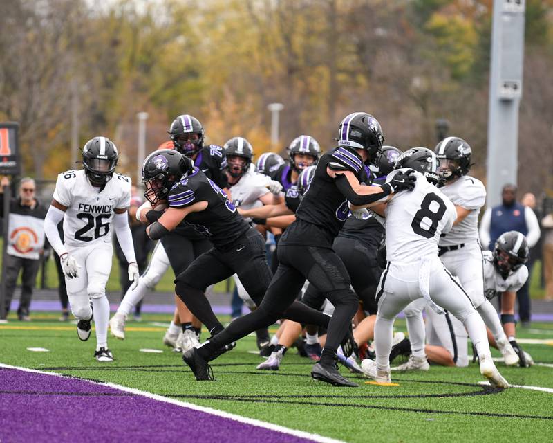 Downers Grove North's Jake Gregorio, center, gets by Fenwick defenders for a touchdown during the second week of the class 7A game on Saturday Nov. 9, 2024, held at Downers Grove North.
