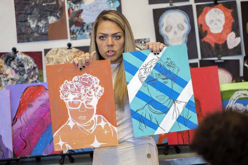 Sterling Challand Middle School art teacher Michelle Campbell goes over a project with her 8th grade class.