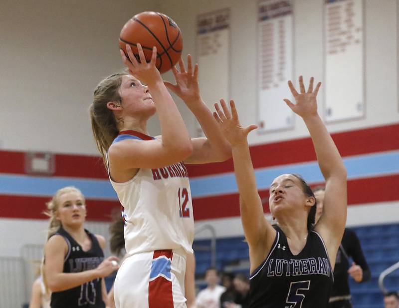 Marian Central's Madison Kenyon shoots the ball over Rockford Lutheran's Addie Richard during a non-conference girls basketball game Monday, Dec. 12, 2022, between Marian Central and Rockford Lutheran at Marian Central Catholic High School, in Woodstock.