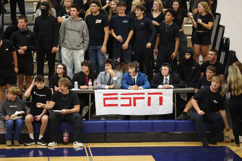 Peotone students in the fan section, some mimicking ESPN courtside commentators, watch the varsity volleyball game during the Blue Devils' loss in three sets, 19-25, 25-19, 25-21, to Manteno on Tuesday, Sept. 23, 2025.