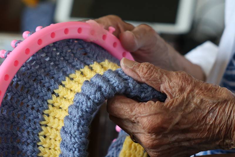 Dolores Spangler, 95 years old, took up knitting stocking caps during the pandemic in 2020 and since has knitted over 400 hats, that she gives away in exchange for a photo wearing her work.