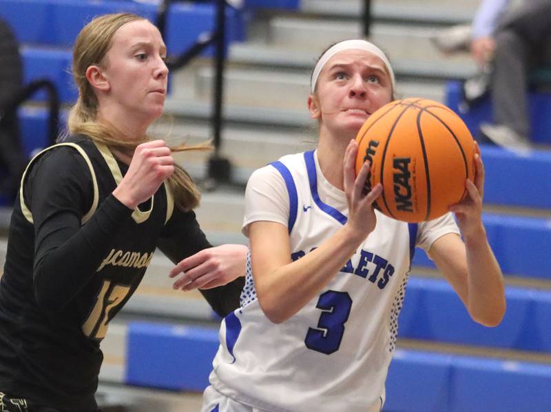 Burlington Central’s Julia Scheuer, right, gets past Sycamore’s Sadie Lang in girls basketball at Burlington Central High School in Burlington on Tuesday, November 18, 2025.