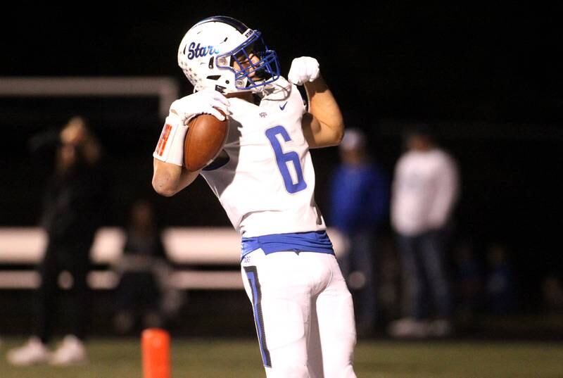 St. Charles North’s Drew Surges flexes after scoring a touchdown during a game at Geneva on Friday, Sept. 23, 2022.
