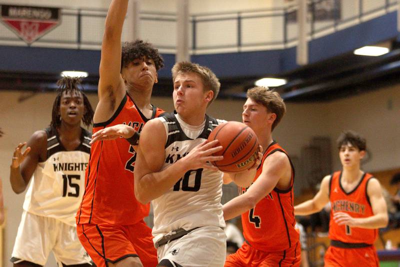 McHenry’s  Adam Anwar defends as Kaneland’s Troyer Carlson moves the ball in Hoops for Healing basketball tournament championship game action at Woodstock Wednesday.