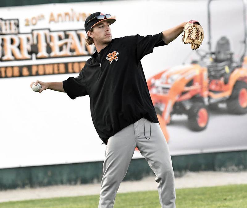 Schaumburg Boomers relief pitcher Derek DeYoung, a Plainfield Central graduate, warms up the left 
fielder before the start of a half-inning during last Friday's game against the Joliet Slammers at Silver 
Cross Field.