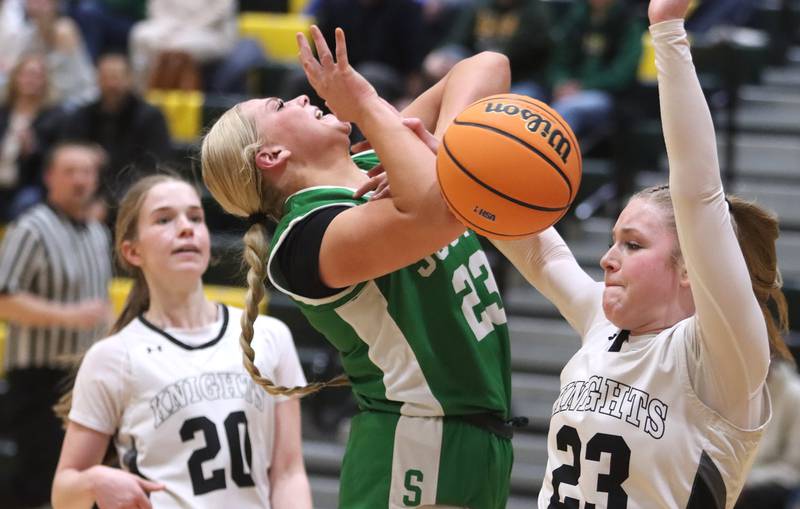 Crystal Lake South’s Laken LePage, left, is fouled by  Kaneland’s Kendra Brown in IHSA Class 3A Regional Title Game girls basketball action on Friday, Feb. 21, 2025, at Crystal Lake South High School in Crystal Lake.