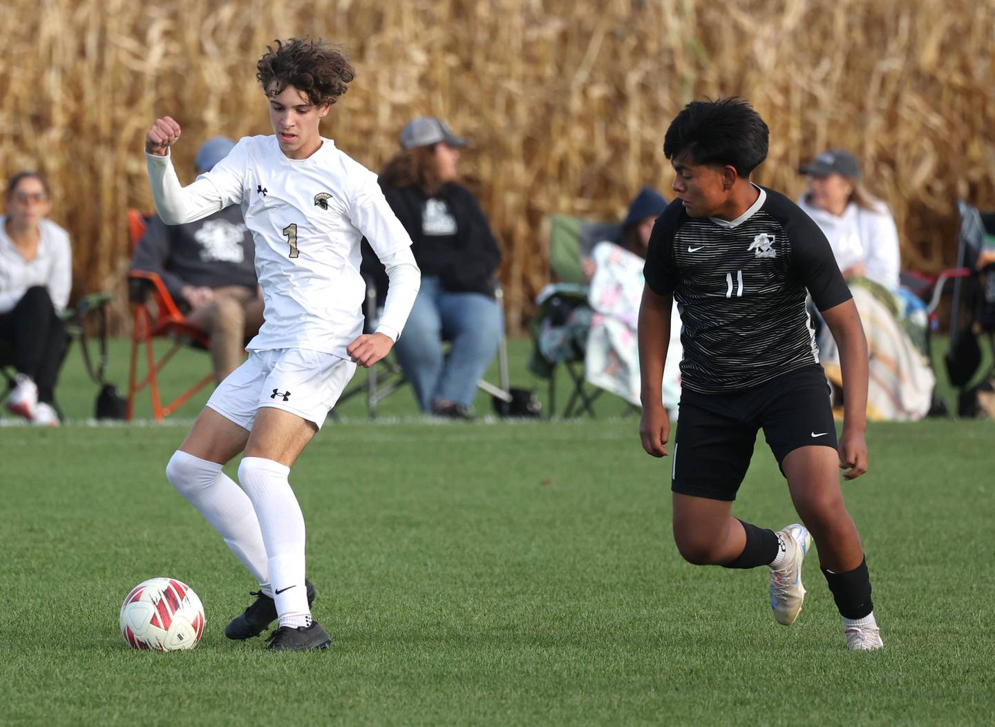 Sycamore's Noah Daykin tries to keep the ball away from Kaneland's Abe Paulino during their game Monday, Oct. 7, 2024, at Kaneland High School in Maple Park.