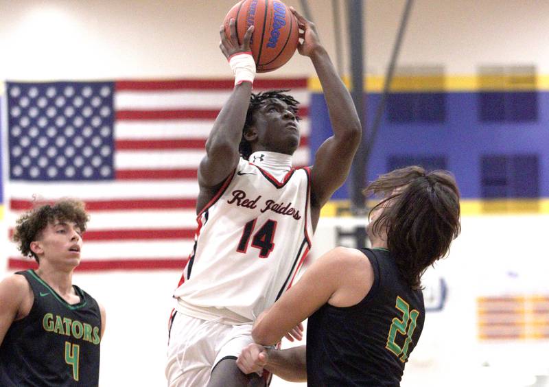 Huntley’s Sheldon Bonsu takes the ball to the hoop against Crystal Lake South in varsity basketball tournament title game action at Johnsburg Friday.