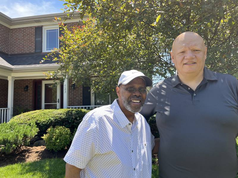 Tab Martin (left) standing with Antonio Rivera outside of their homes on Thursday, June 30, 2022 in Bolingbrook.