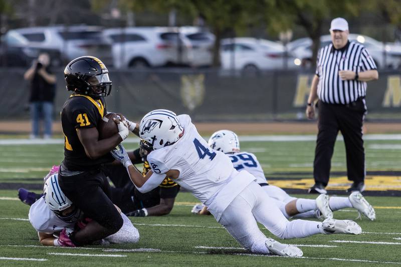 Plainfield South's Chase Pierceall tackles Joliet West's Gregory Lee during a varsity football game at Joliet West on Sept. 12, 2025.