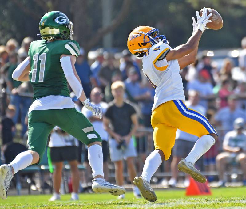 Lyons Township’s (right) intercepts a pass intended for Glenbard West’s Chase Cavan (11) during a game on September 27, 2025 at Glenbard West High School in Glen Ellyn.