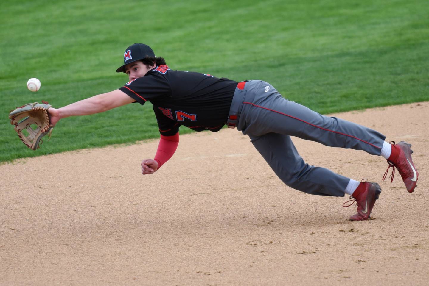 Marian Central's TJ Cutrona makes a diving attempt at a Bishop McNamara hit during a game at Bishop McNamara Friday, April 17, 2026.