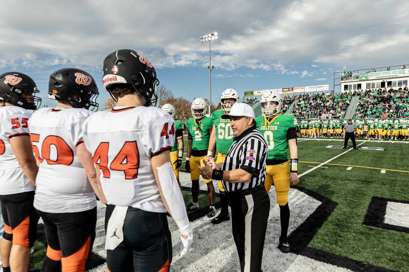 The captains from Providence and Washington meet at the 50-yard-line for the coin toss prior to a 5A varsity football playoff game at Providence on Nov. 15, 2025.