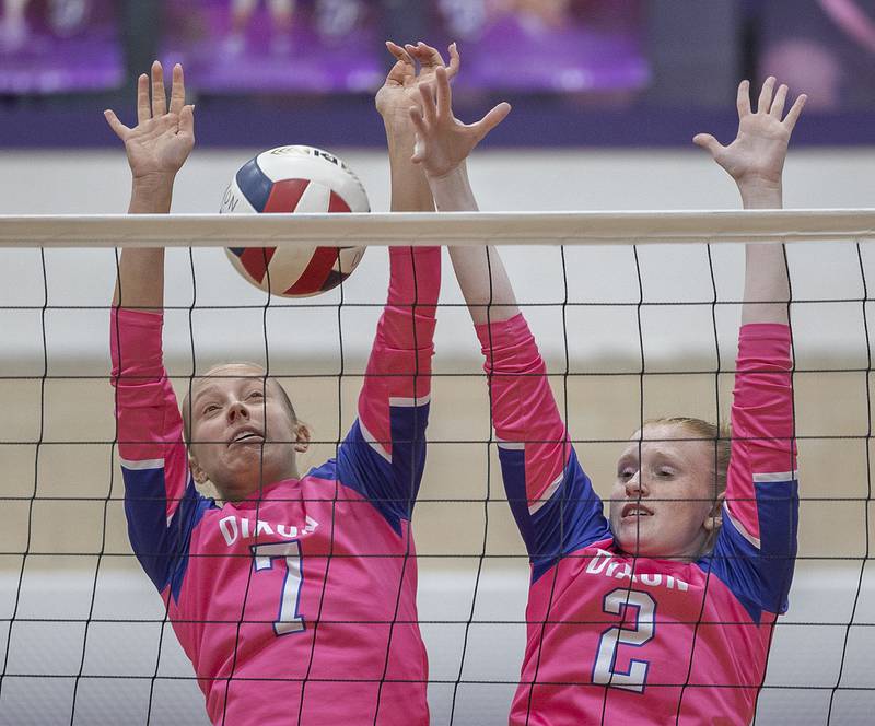 Dixon’s Makenzie Toms (left) and Madyson Tichler go up for a block against Genoa-Kingston Thursday, Oct. 17, 2024.