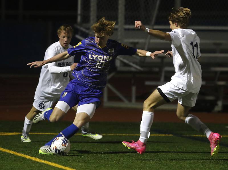 Lyons Township's Haris Sarajlija plays the ball between New Trier's Ian Vichnick (left) and Cole Driscoll during the IHSA Class 3A state championship soccer match on Saturday, Nov. 4, 2023, at Hoffman Estates High School.