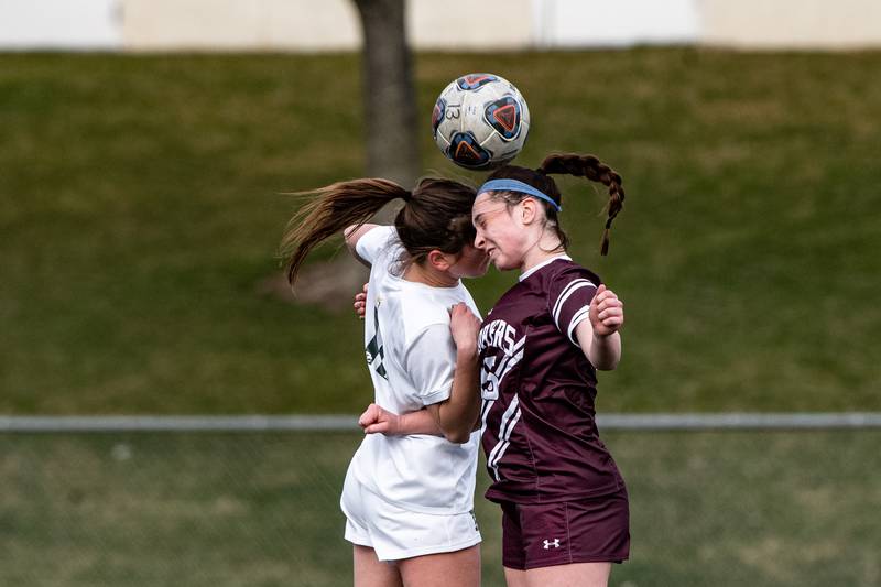 ockport's Kaylin Klutcharch and Providence Catholic's Maggie Wolniakowski both go up for a header during a game against  Thursday March 30, 2023 at Lockport East High School