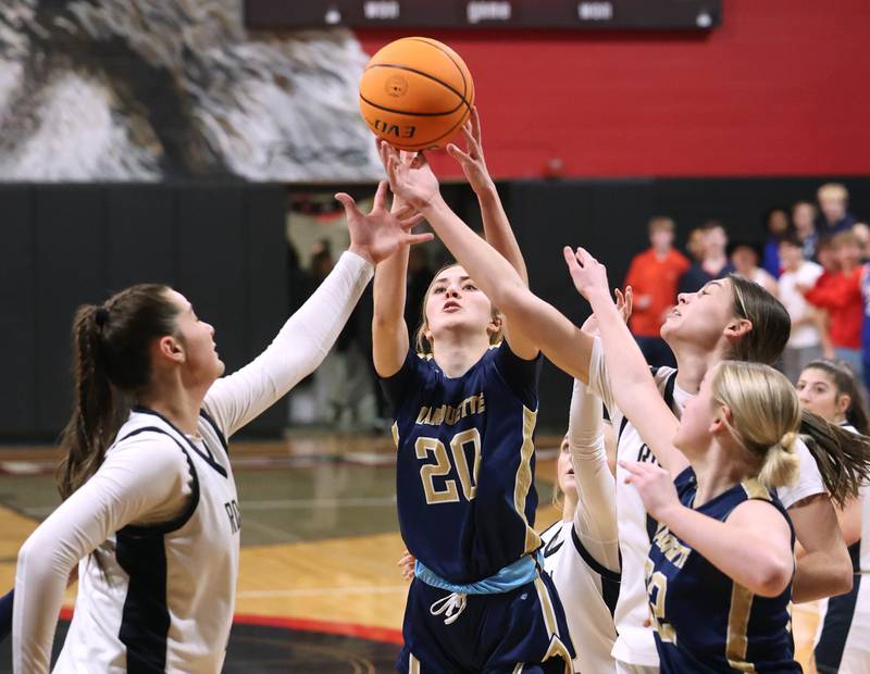 Marquette's Kaitlyn Davis grabs a rebound between two Rockford Christian players Tuesday, Feb 24, 2026, during their Class 1A sectional semifinal game at Indian Creek High School in Shabbona.