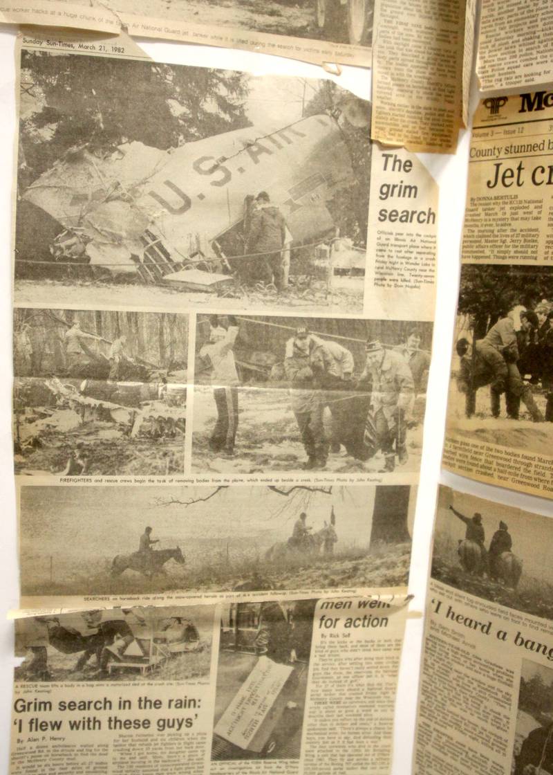 News clippings are displayed as a remembrance was held Saturday at Wonder Lake Fire Protection District Station 2 on the 40th anniversary of a midair military jet explosion that happened over the small, rural area northeast of Woodstock. The plane exploded midair at 9:11 p.m. on March 19, 1982, its flaming pieces raining over a 2-mile area near Greenwood. On board were more than two-dozen members of the Air Force Reserve and Air National Guard. Twenty-seven people died.