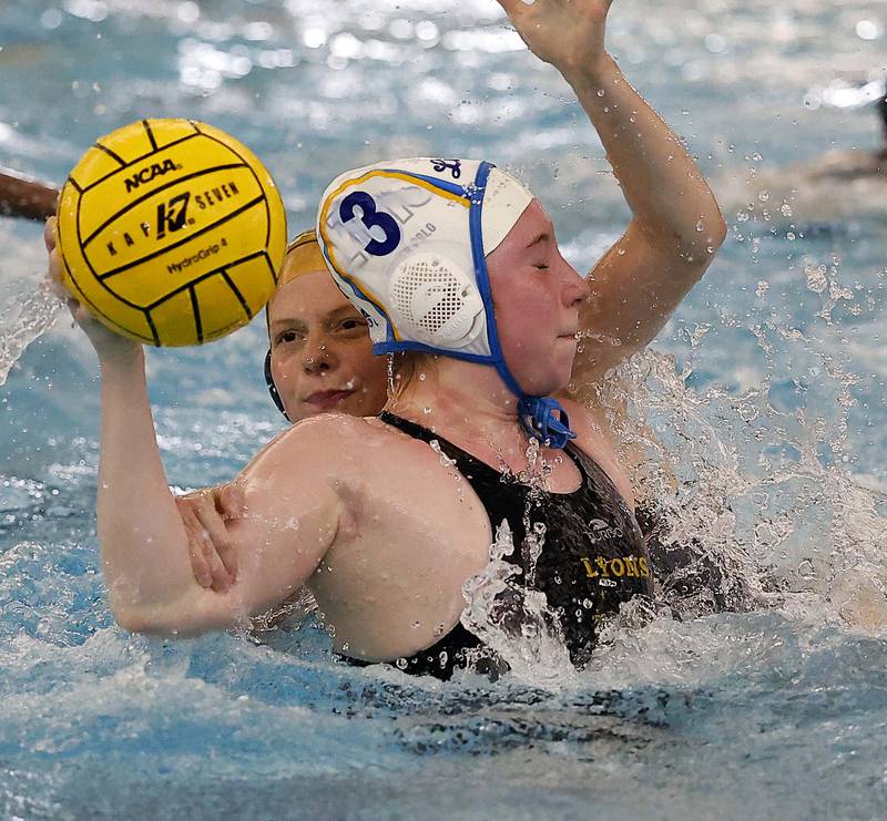 Lyons Township's Isabella Recker (3) gets wrapped up by Stevenson's Olivia Spieth (10) during the IHSA State Finals of the Girls Water Polo Saturday, May 24, 2025 at Stevenson High School in Lincolnshire.