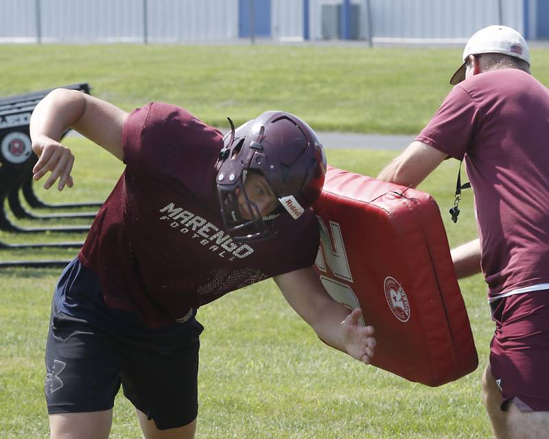Marengo’s Ryan Grismer runs a blocking drill during football practice on Tuesday, July 22,  2025, at Marengo High School.