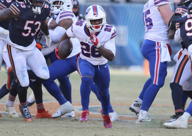 Buffalo Bills running back Devin Singletary breaks through the Chicago Bears defensive line during their game Sunday, Dec. 24, 2022, at Soldier Field in Chicago.
