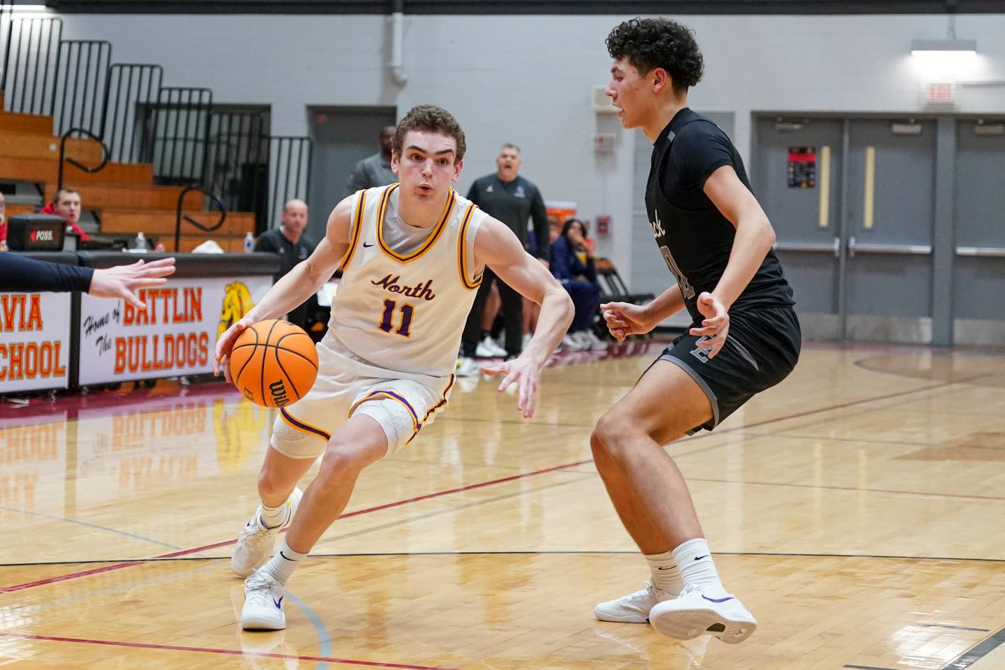 Downers Grove North's Jack Crowley (11) drives to the basket against Oswego East's Damien Lewandowski (10) during a Batavia Night of Hoops Basketball game at Batavia High School on Saturday, Jan. 25, 2025.