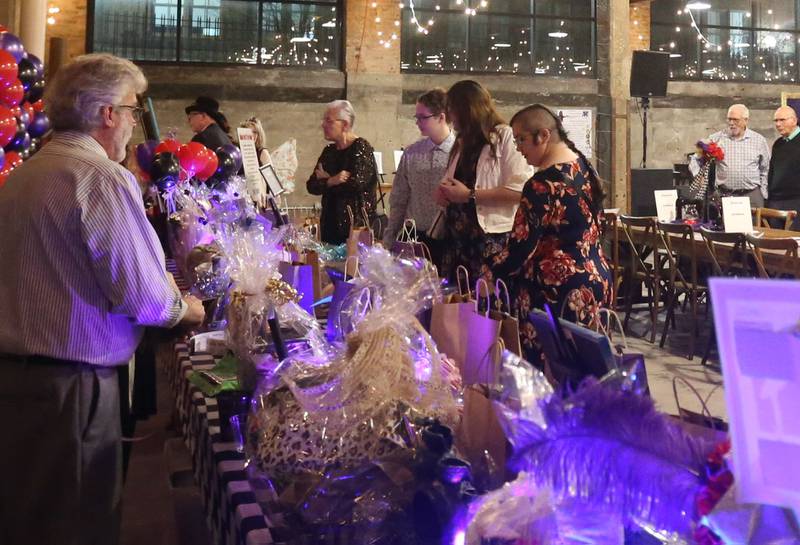 Attendees participate in raffles during the 9th annual NCI Artworks Mad Hatter Ball on Friday, Jan. 16, 2026 at the Westclox Event Center in Peru.