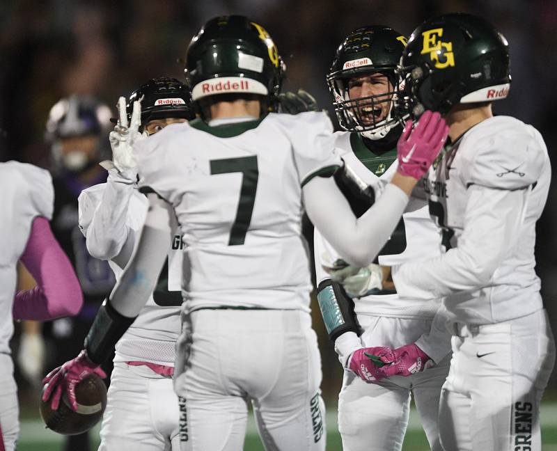 Elk Grove’s Garrett Ewen, left, holds up two fingers as he celebrates the second interception made by teammate Lucas Rodgers (7) in a football game in Rolling Meadows on Friday, October 7, 2022.