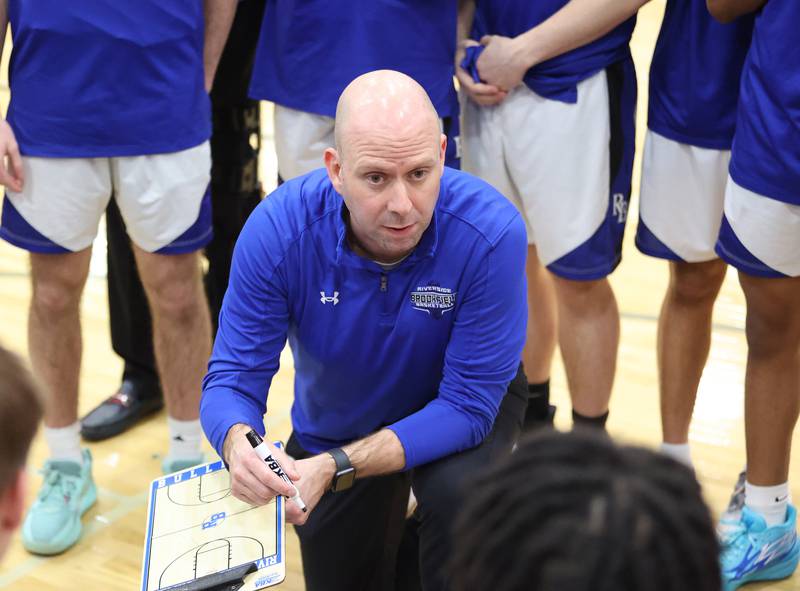 Riverside Brookfield coach Mike Reingruber talks to the team during the boys varsity basketball game between IC Catholic Prep and Riverside Brookfield in Riverside on Tuesday, Jan. 24, 2023.