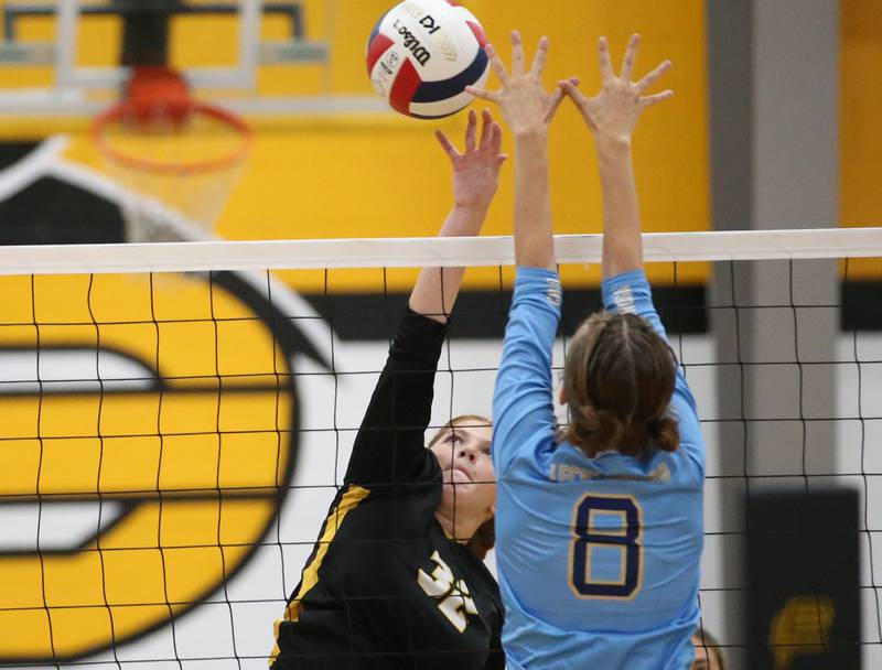 Putnam County's Maggie Spratt hits the ball past Marquette's Mary Lechtenberg on Thursday, Sept 7, 2023 at Putnam County High School.