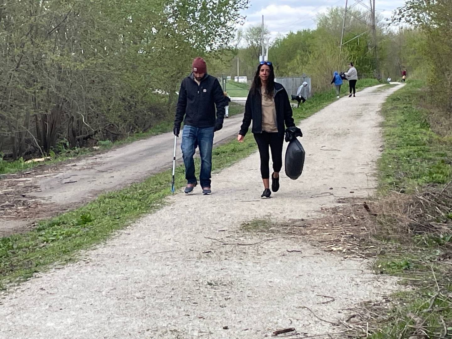 Joseph Whiting of Peru and Holly Disch of Peru help scour the trail for litter near Lock 16 in La Salle during the Earth Day Community Cleanup on Saturday, April 20, 2024. "It's our first time," Disch said. "It’s a good cause. It won’t be our last time, that’s for sure."