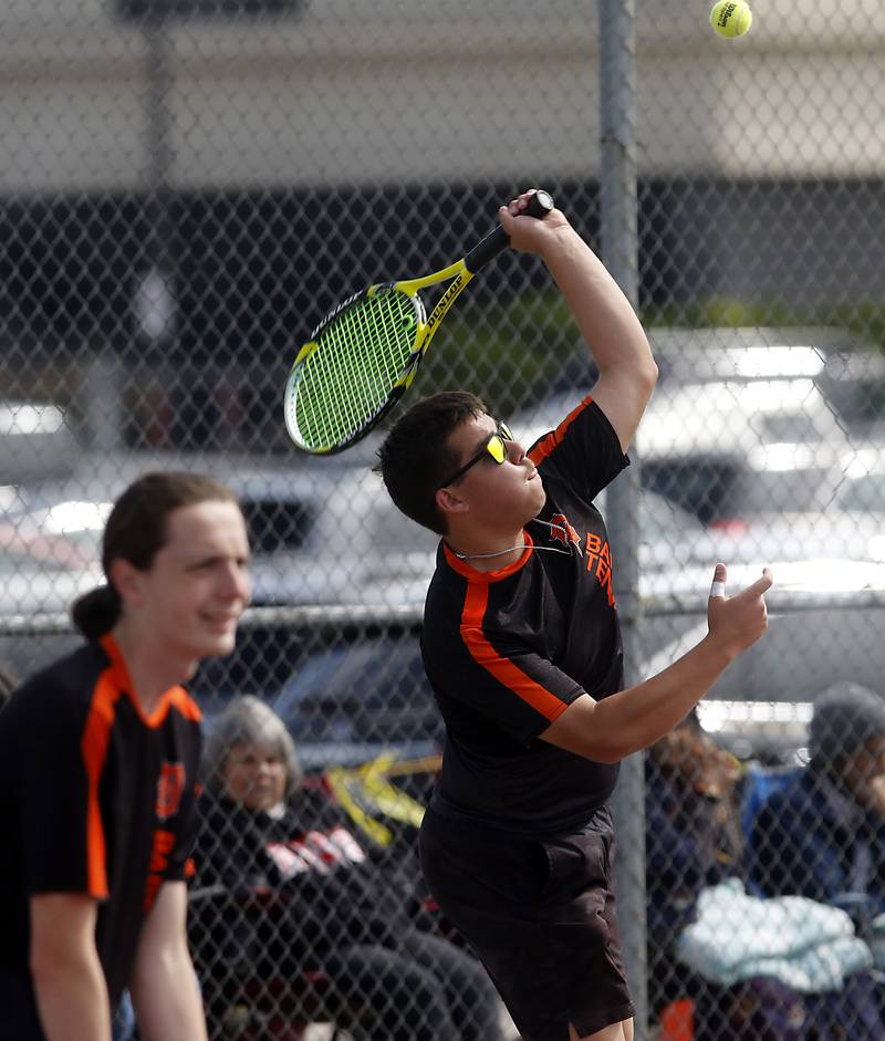 DeKallb’s Esteban Cardoso serves the ball as he and his doubles partner, Kameron Falk, compete in the Class 2A Boys State Tennis Tournament on Thursday, May 29, 2025, at Palatine High School.