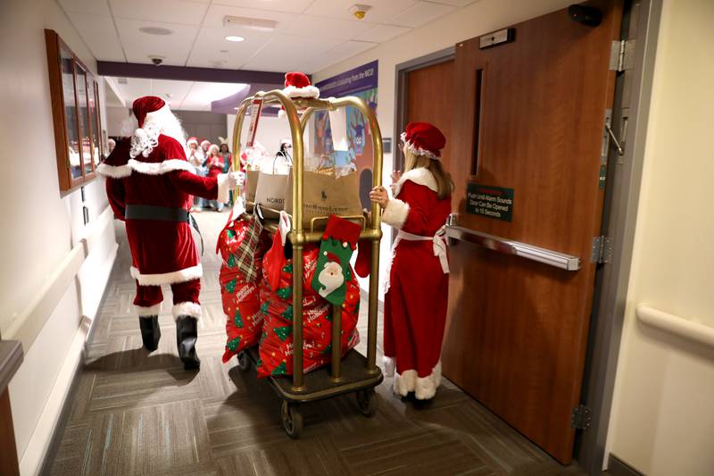 Santa and Mrs. Claus enter the NICU at Northwestern Medicine Central DuPage Hospital in Winfield on Wednesday, Dec. 20, 2023.