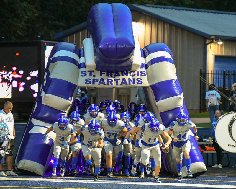 St. Francis’s football team runs onto the field before the start of the game on Friday Sep. 22, 2023, as they took on Joliet Catholic Academy at St. Francis in Wheaton.