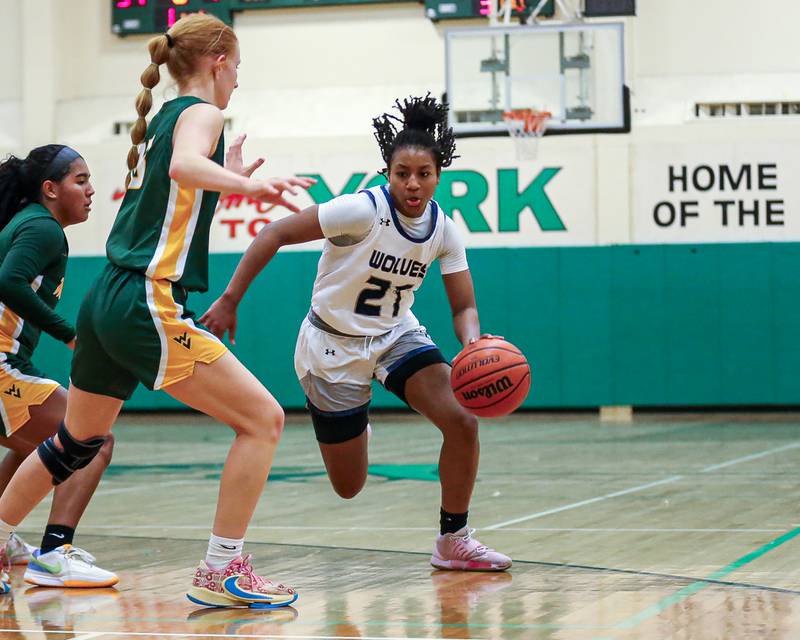 Oswego East's Desiree Merritt (21) makes a move from the top of the key at the York Thanksgiving Tournament. Nov 13, 2023.