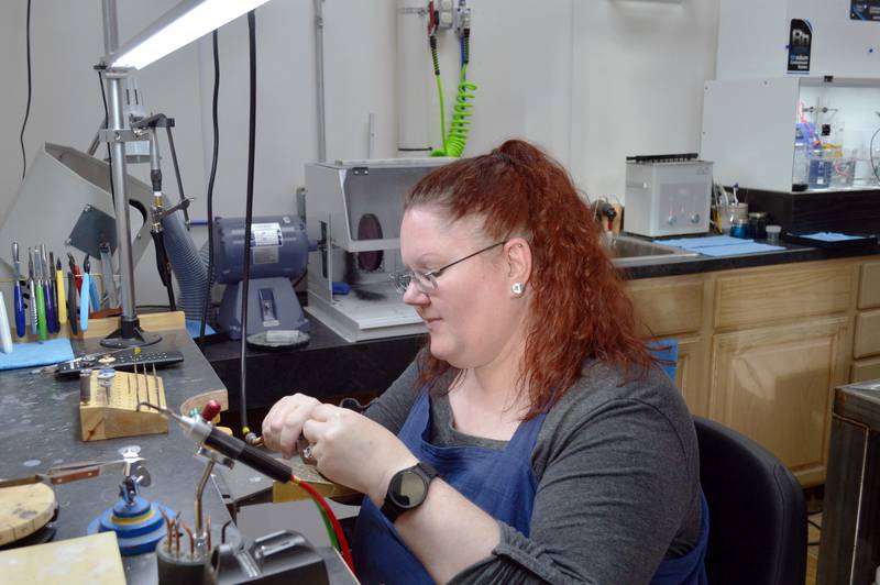 Jen Brooks, owner of Brooks Jewelers, polishes a ring on Saturday, Nov. 2, 2024, in the Oregon-based shop.