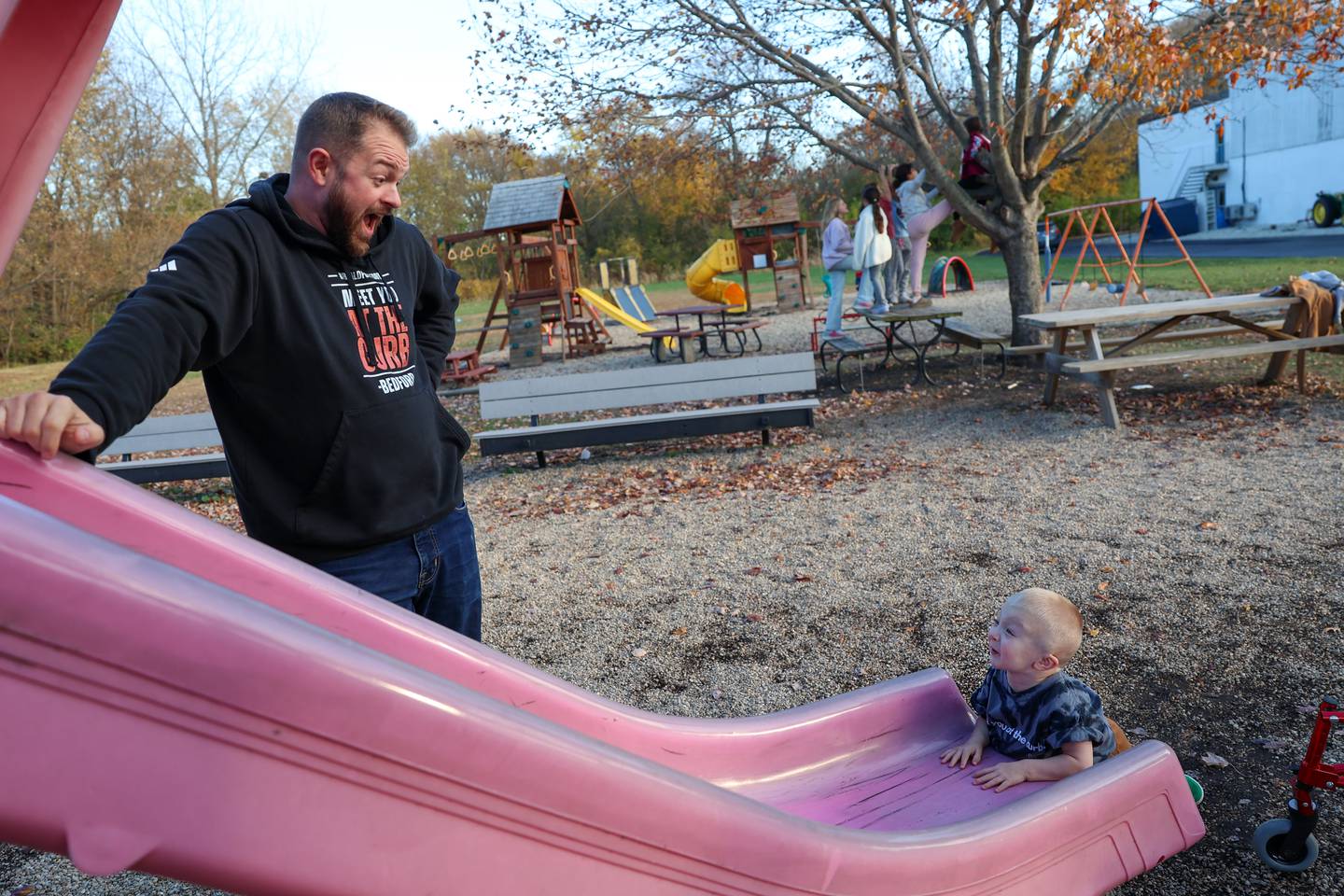 Bedford Erickson, 2.5, plays on the slide with his dad, Jesse, at Grace Christian Academy on Nov. 7, 2025. Erickson, who was born with Schwartz-Jampel Syndrome, was selected for a fundraiser to bring an inclusive playground to the school, where he'll start next year.