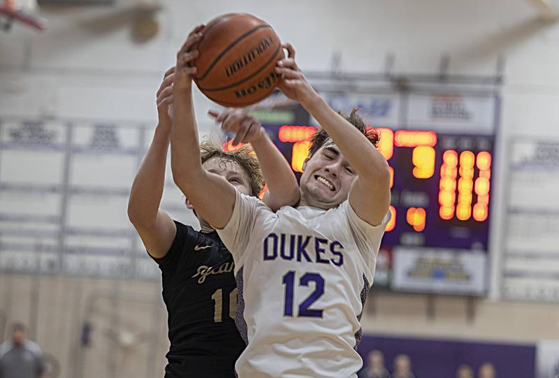 Dixon’s Mason Weigle pulls down a rebound against Sycamore’s Isaiah Feuerbach Tuesday, Jan. 23, 2024 at Dixon High School.