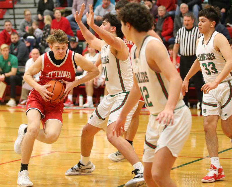 Ottawa's Owen Sanders passes by the lane while being guarded by L-P's Josh Senica on Friday, Jan. 5, 2024 at Sellett Gymnasium.