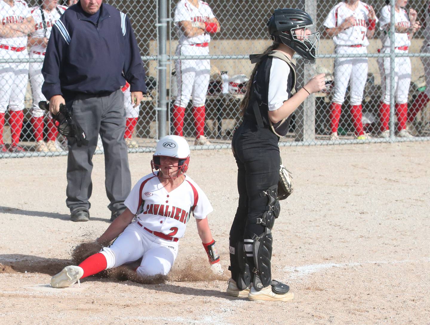 L-P's Karmen Piano slides into home plate to score the teams first run against Kaneland on Tuesday, April 18, 2023 at Veterans Park in Peru.