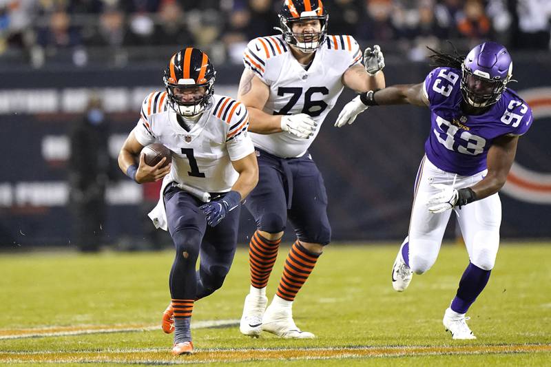 Chicago Bears quarterback Justin Fields advances the ball past the block of offensive tackle Teven Jenkins as Minnesota Vikings defensive end Patrick Jones II pursues during the first half Monday, Dec. 20, 2021, in Chicago.